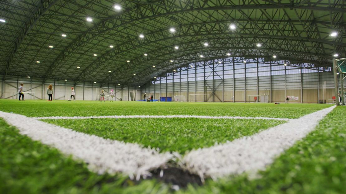 Local children play inside the indoor football football on Heimaey. 