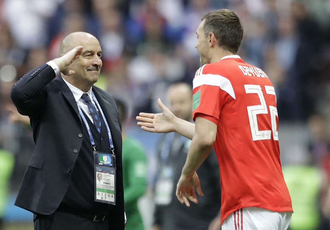 Russia head coach Stanislav Cherchesov, left, salutes to goal scorer Artyom Dzyuba