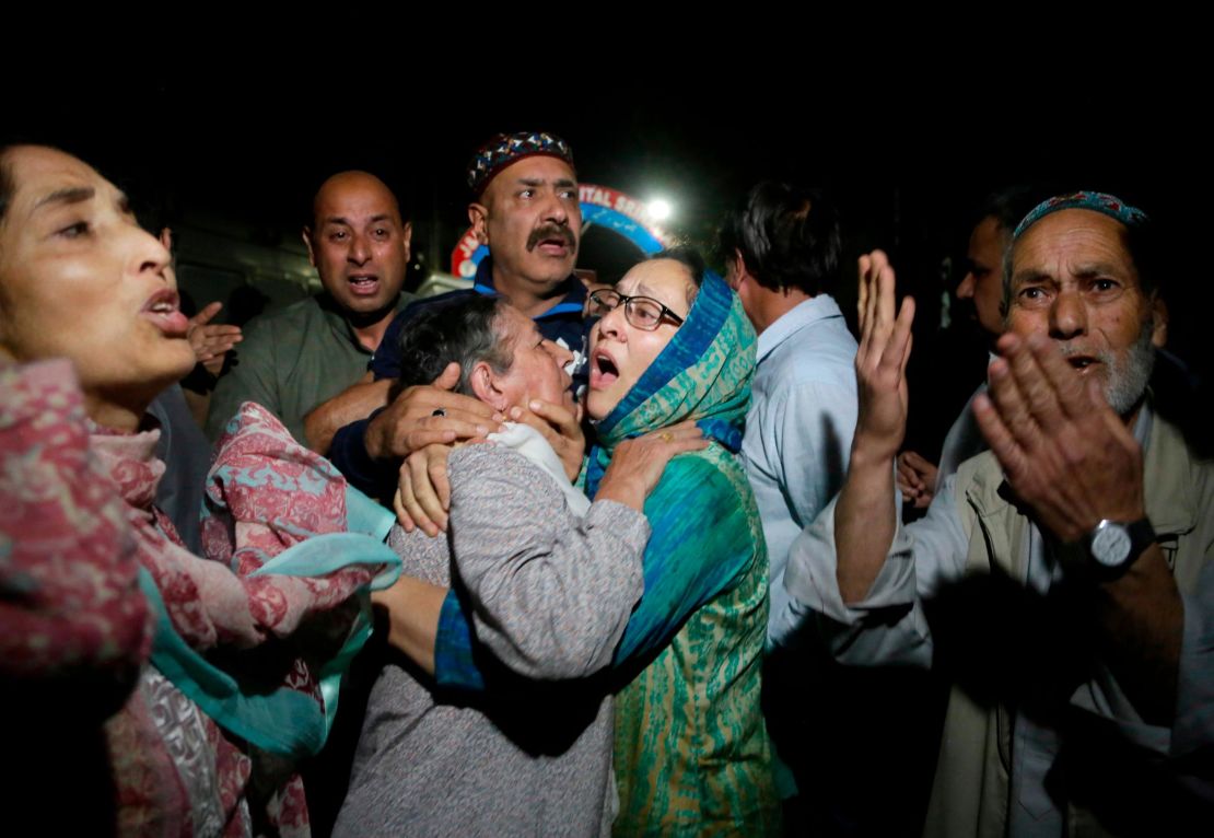 Relatives and friends of journalist Shujaat Bukhari cry inside a police control room in Srinagar, India, Thursday, June 14, 2018.  Mukhtar Khan/AP