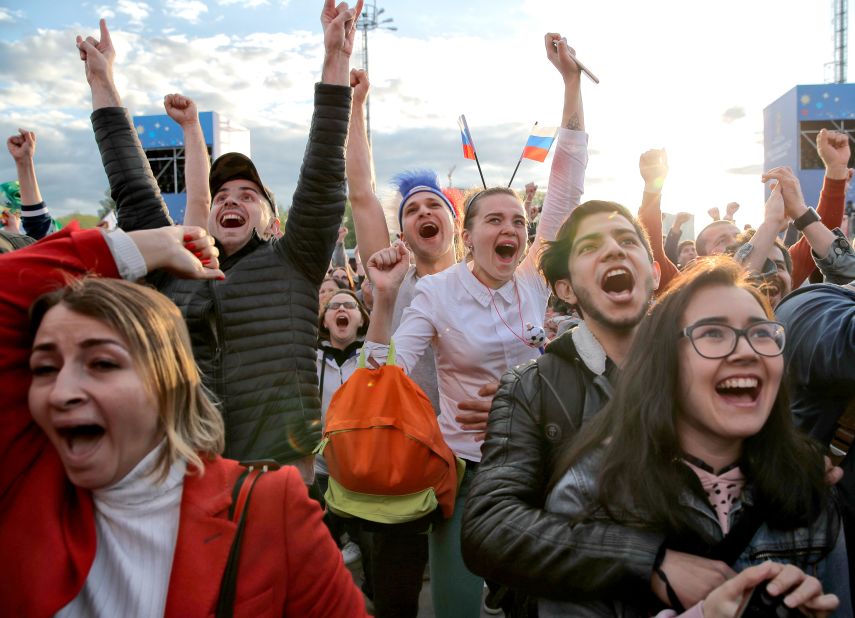 Fans watching from Yekaterinburg, Russia, celebrate Russia's first goal.