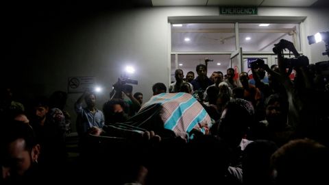 Friends and relatives carry out the body of journalist Shujaat Bukhari from a police control room in Srinagar, India, Thursday.