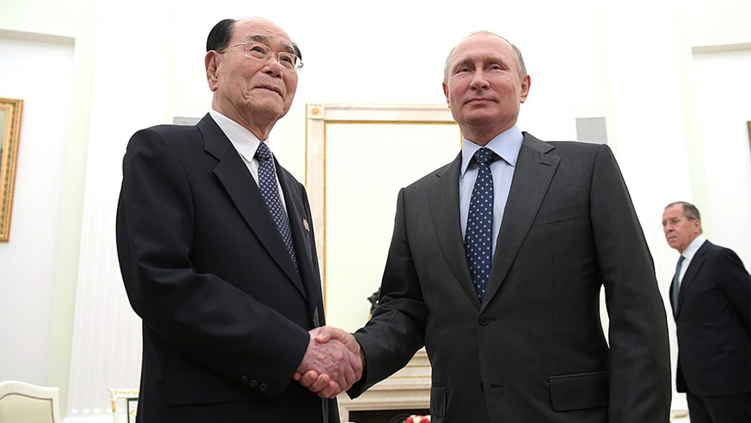 Russian President Vladimir Putin and  senior North Korean official Kim Yong-nam shake hands in Moscow
