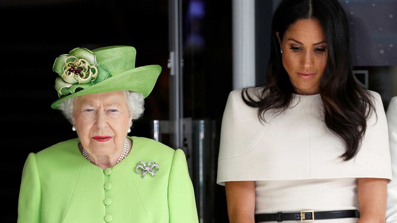 Queen Elizabeth and the Duchess of Sussex observe a moment of silence in memory of the victims. 