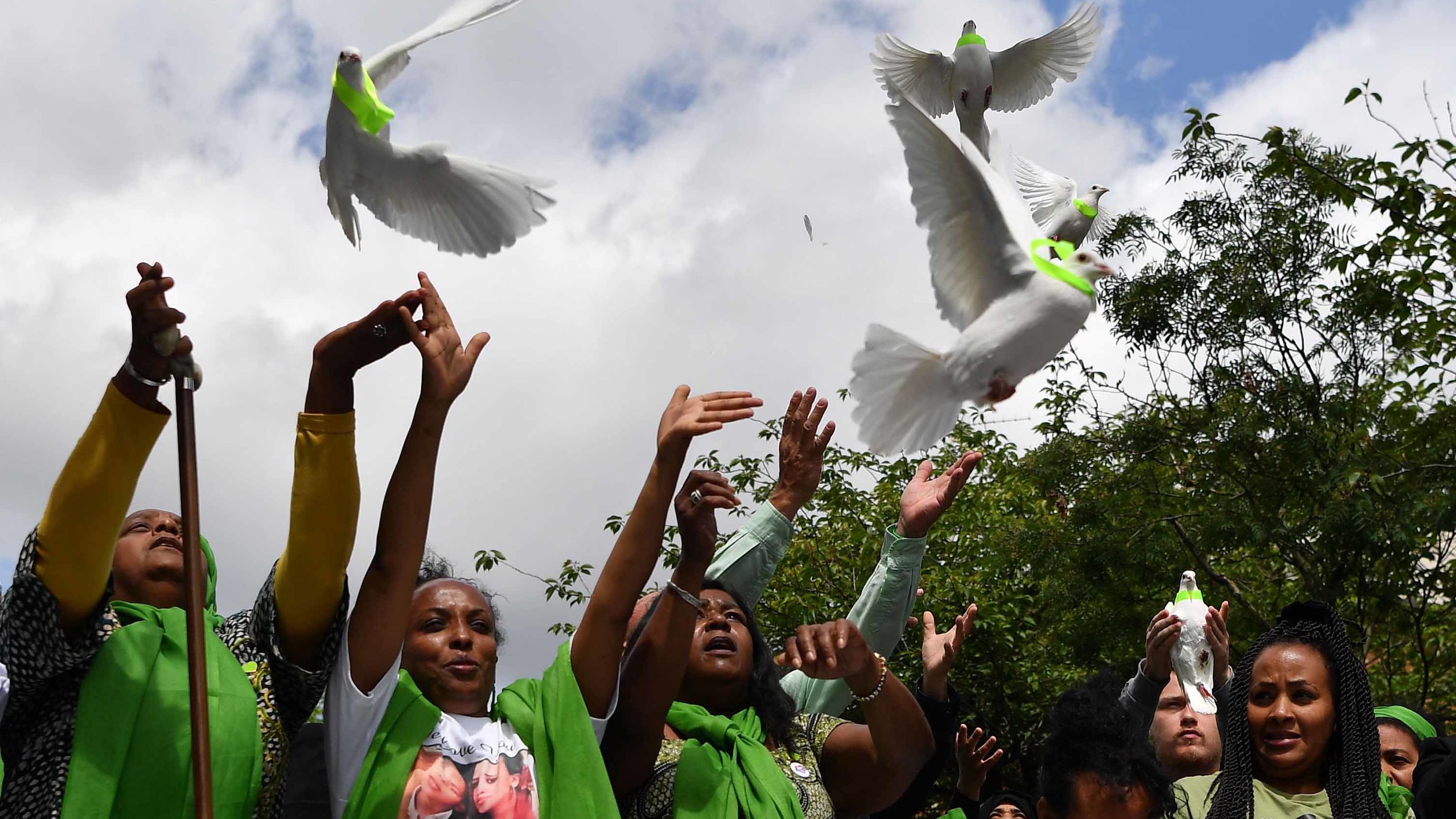 Members of the public release doves as part of commemorations on the anniversary of the fire.