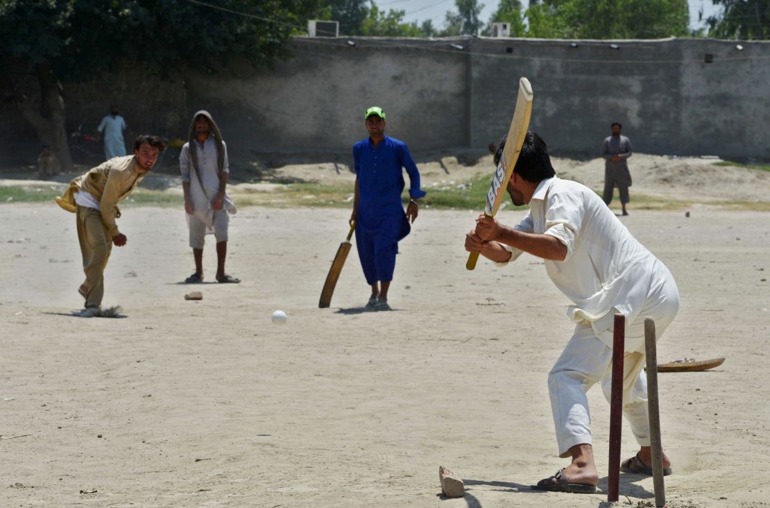 Afghan refugees play a cricket match at the Khurasan refugee camp in the suburbs of Peshawar on July 6, 2017.