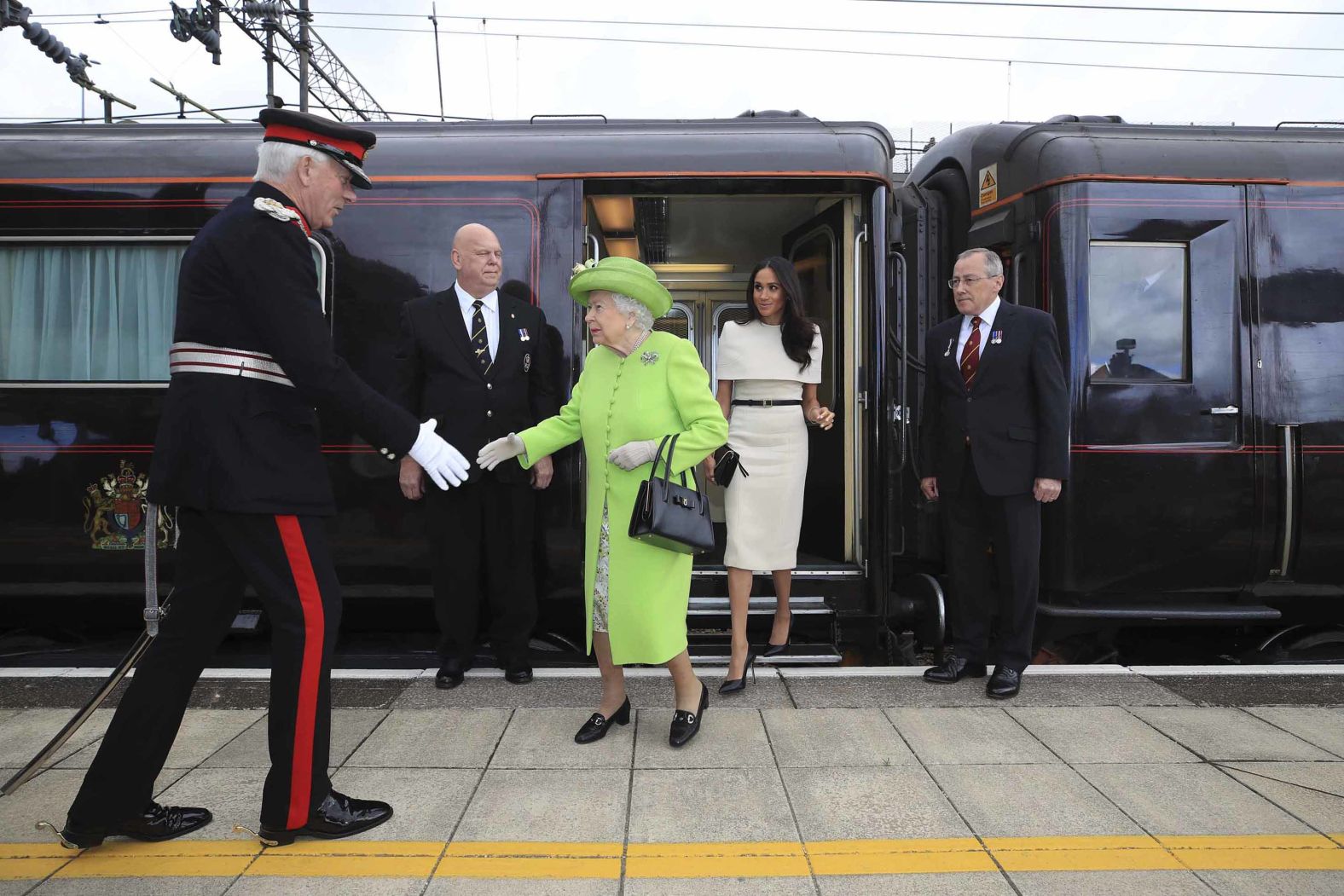 Queen Elizabeth and Meghan arrive by royal train at Runcorn Station in Northwest England.