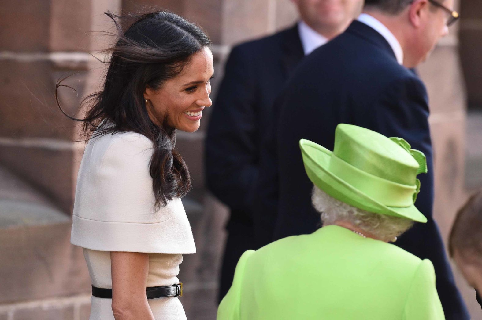 Meghan smiles at Queen Elizabeth as they depart Chester Town Hall.