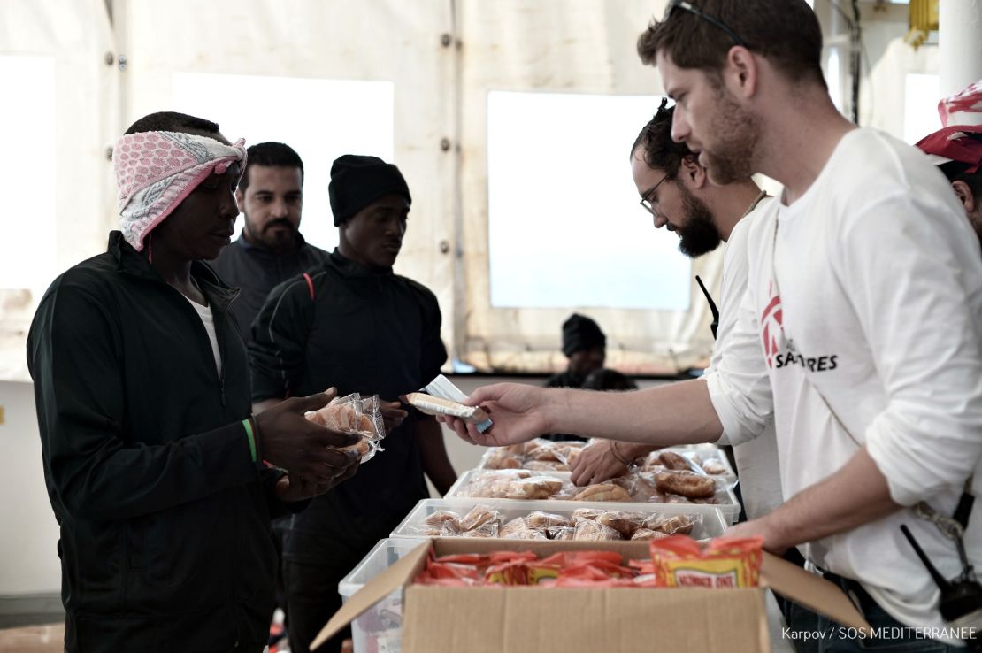 An MSF team serves rescued people breakfast on Friday made from food supplies delivered to the Aquarius the previous day.