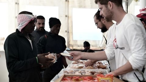 An MSF team serves rescued people breakfast on Friday made from food supplies delivered to the Aquarius the previous day.