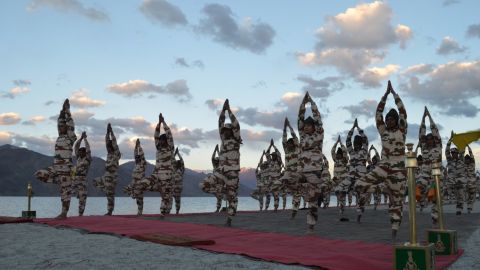 Members of the Indo-Tibetan Border Police practice tree pose during a yoga class in the Himalayan mountains.