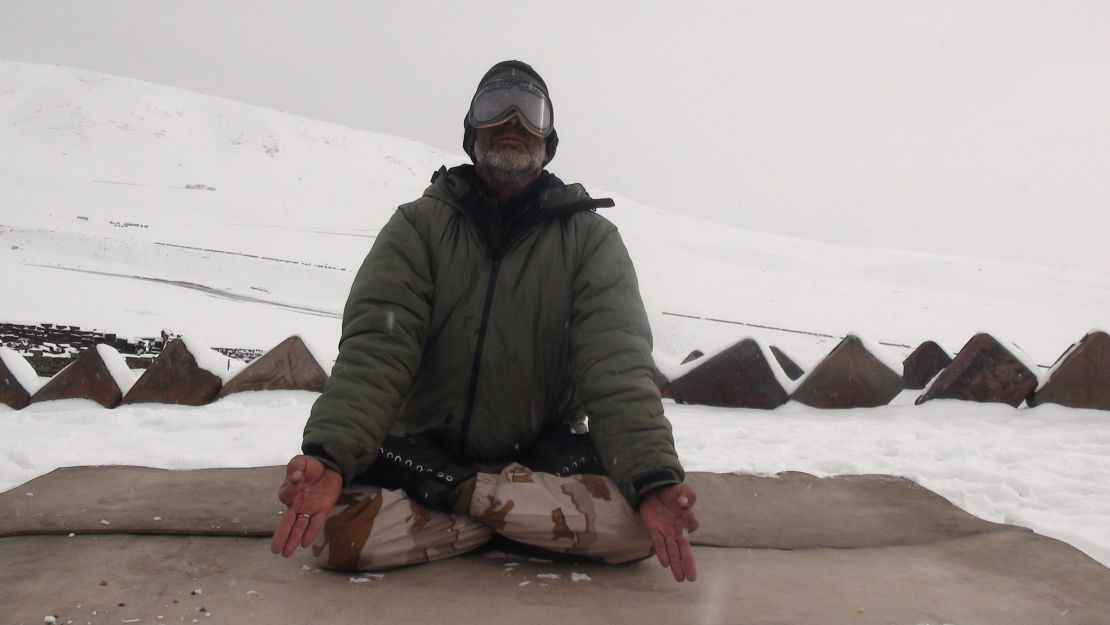 A member of the Indo-Tibetan Border Police meditates during a yoga session at a military post in the Himalayan mountains.