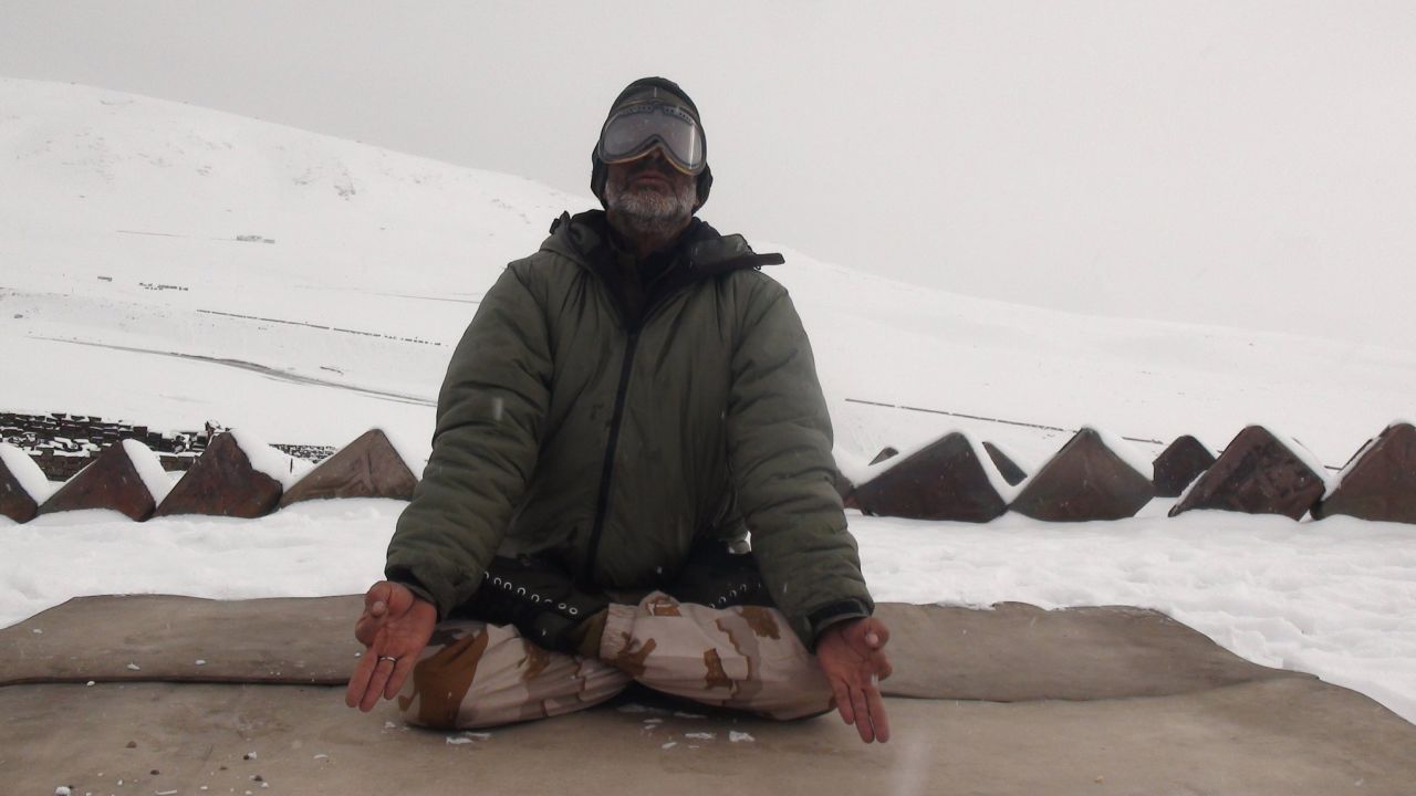 A member of the Indo-Tibetan Border Police meditates during a yoga session at a military post in the Himalayan mountains.