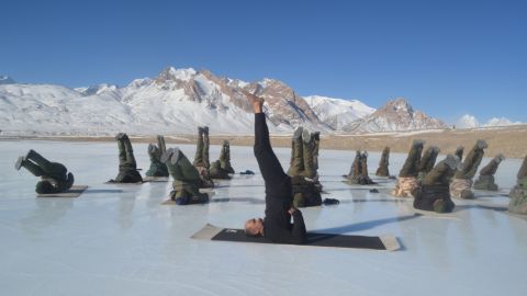 Members of the Indo-Tibetan Border Police practice yoga on a frozen lake in the Himalayan mountains ahead of International Yoga Day.