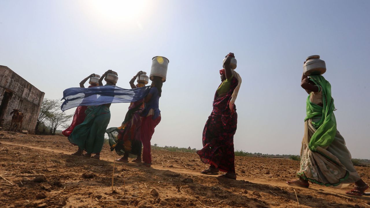 Indian women fetch water from a pit in the bed of Lokpal Sagar Lake in Madhya Pradesh. 