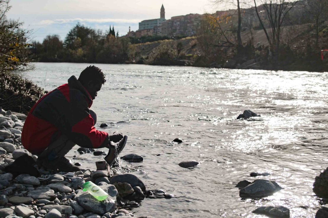 In December 2017, a migrant washes his shoes in the river Roya, which runs through the town of Venitmiglia.