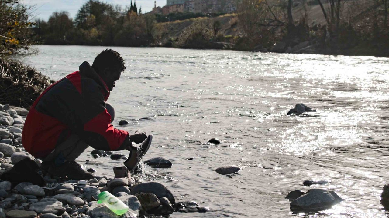 In December 2017, a migrant washes his shoes in the river Roya, which runs through the town of Venitmiglia.
