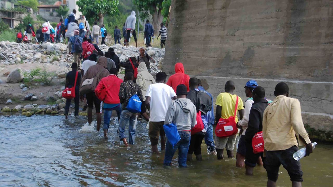 A picture of migrants walking along the Roja river, near Ventimiglia, Italy northwest, towards the French border. Around 400 refugees left the camp on the bank of the Roja river in Ventimiglia shortly after midnight to try to cross the border with France led by some German activists. Ventimiglia, Imperia, Italy, 26 June 2017. ANSA/ CHIARA CARENINI (ANSA via AP)