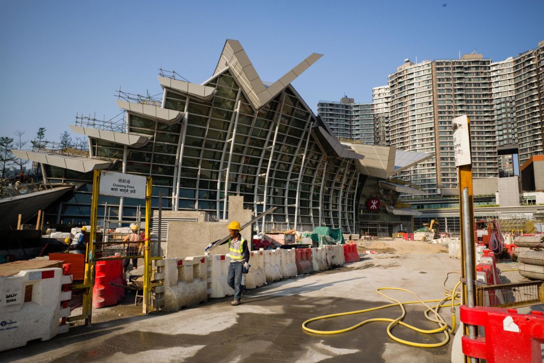 A worker walks outside the West Kowloon station of the Express Rail Link train to Guangzhou in Hong Kong on March 23.