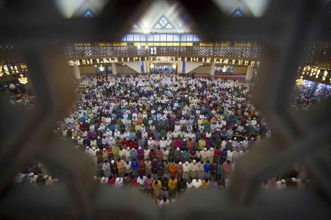 Muslims in Kuala Lumpur, Malaysia, offer prayers during the first day of Eid al-Fitr on Friday, June 15.