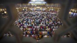 Malaysian Muslims offer prayers during the first day of Eid al-Fitr, which marks the end of the holy fasting month of Ramadan in Kuala Lumpur, Malaysia, Friday, June 15, 2018. (AP Photo/Vincent Thian)
