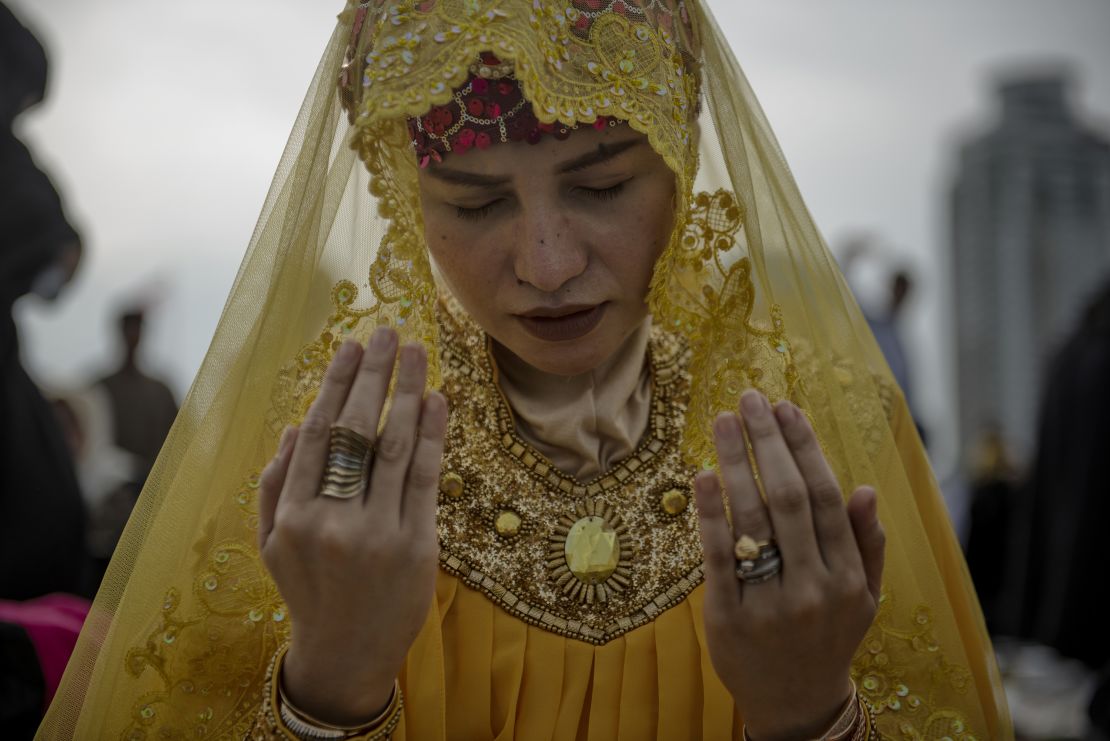 A woman prays in a park during Eid al-Fitr celebrations in Manila, Philippines in 2018.