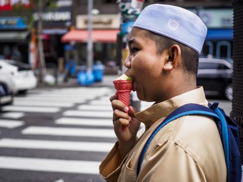 A boy eats ice cream near the Seoul Central Mosque in Seoul, South Korea.