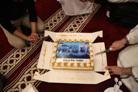 Worshippers at the Al Manaar mosque in London cut a cake to celebrate Eid.