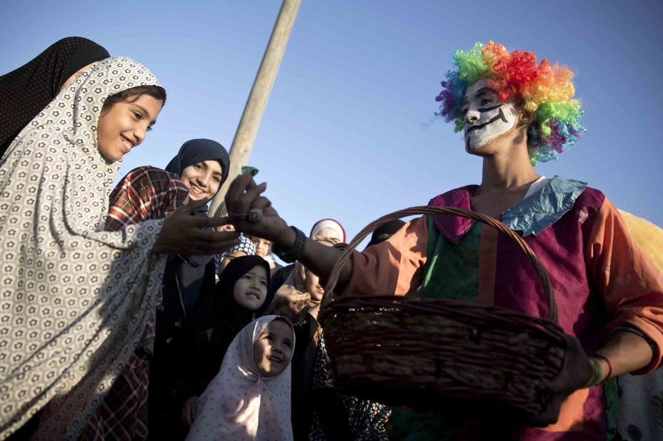 A clown gives out candy in Gaza City.