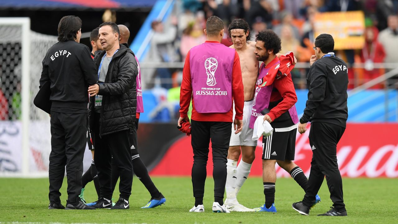 Salah is consoled by Edinson Cavani at the final whistle.