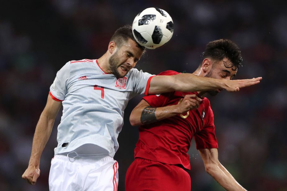 Spanish defender Nacho, left, competes for a header with Portugal's Bruno Fernandes. Nacho conceded the early penalty to Ronaldo but responded with a second-half goal.