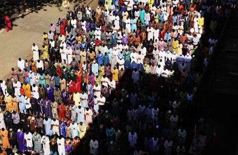 Muslims participate in an outdoor prayer event at the Masjid Aqsa-Salam mosque, Manhattan's oldest West African mosque.