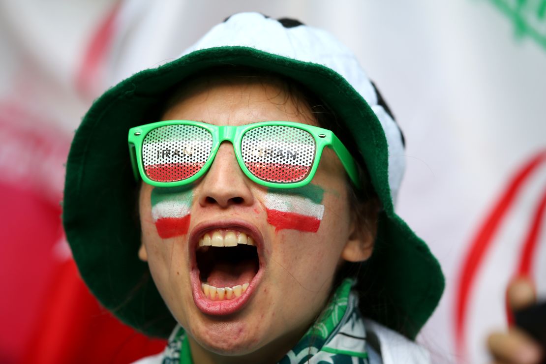 A female Iranian fan cheers on her team against Morocco.