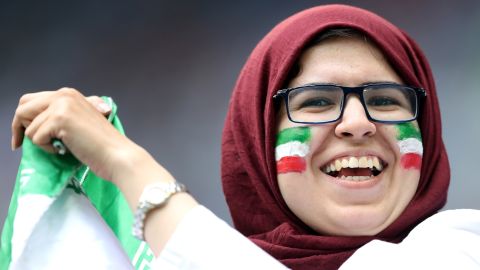 A female Iran fan cheers on her national team against Morocco at the World Cup.