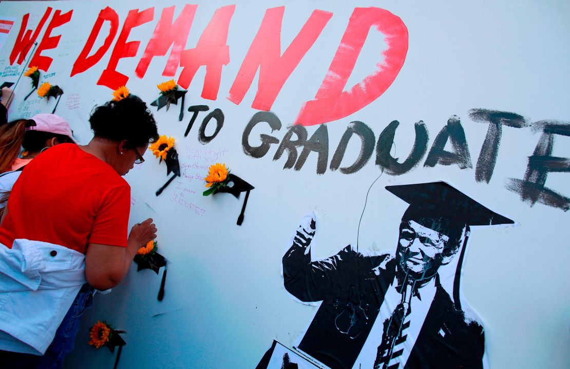 A woman visits a mural at the "End of School Year Peace March and Rally" Friday at St. Sabina Church in Chicago.