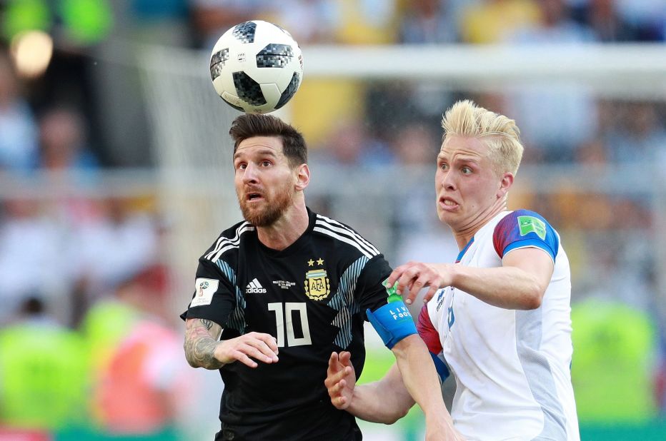 Messi and Iceland's Hordur Magnusson struggle for the ball.