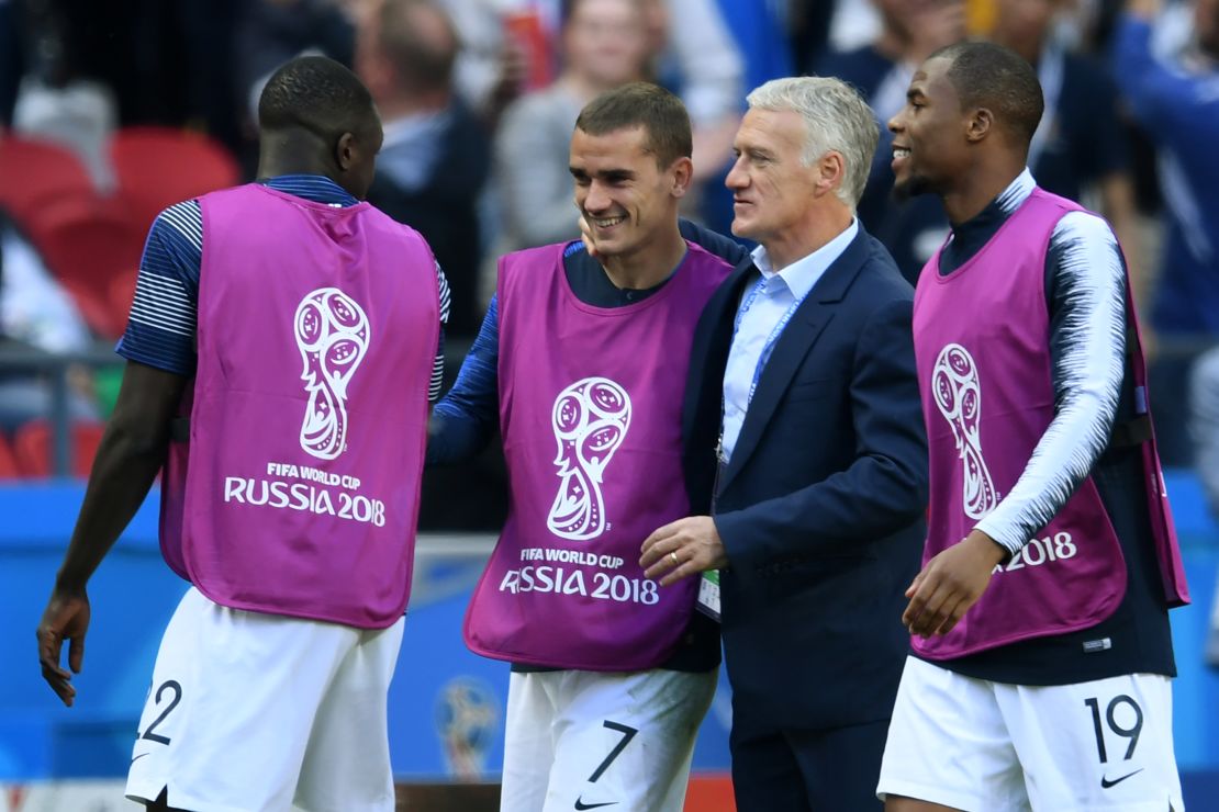 Antoine Griezmann celebrates with France coach Didier Deschamps at the final whistle.