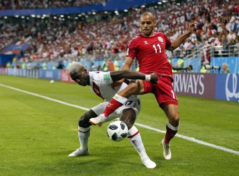 Peru's Luis Advincula, left, and Denmark's Martin Braithwaite fight for the ball.