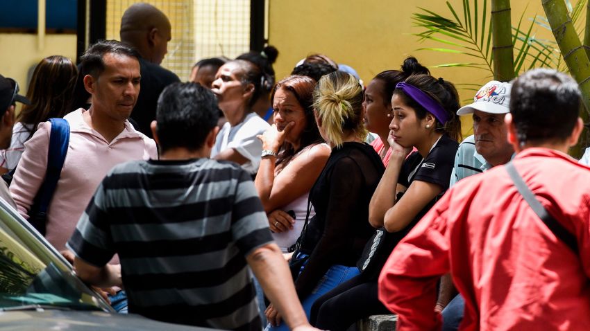 Relatives of the victims of the night club "Los Cotorros" -where a tear gas grenade was detonated earlier today- wait outside the morgue in Caracas on June 16, 2018. - Seventeen people, including eight minors, were killed after a brawl broke out during a middle school graduation party and someone detonated the tear gas, sending more than 500 people rushing for the exits (Photo by Federico PARRA / AFP)        (Photo credit should read FEDERICO PARRA/AFP/Getty Images)