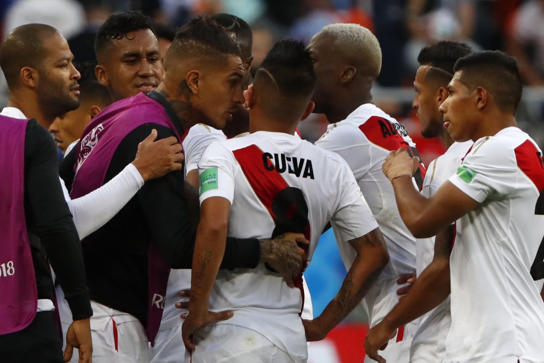 Christian Cueva is consoled by teammates, including captain Paolo Guerrero, after his missed penalty.
