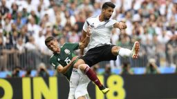 TOPSHOT - Germany's midfielder Sami Khedira (R) and Mexico's defender Hector Moreno (L) fall after attempting to head the ball during the Russia 2018 World Cup Group F football match between Germany and Mexico at the Luzhniki Stadium in Moscow on June 17, 2018. (Photo by Patrik STOLLARZ / AFP) / RESTRICTED TO EDITORIAL USE - NO MOBILE PUSH ALERTS/DOWNLOADS        (Photo credit should read PATRIK STOLLARZ/AFP/Getty Images)