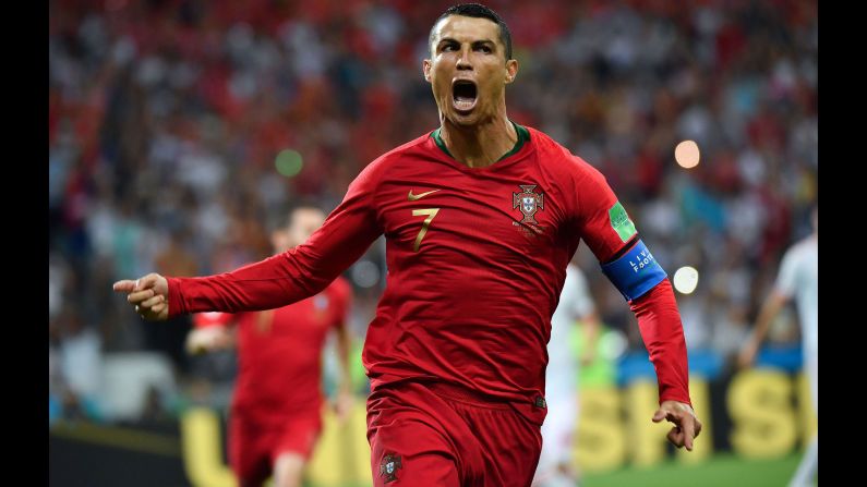 Portugal star Cristiano Ronaldo celebrates his first-half penalty in the World Cup match against Spain on Friday, June 15. He added two more goals in the 3-3 draw.
