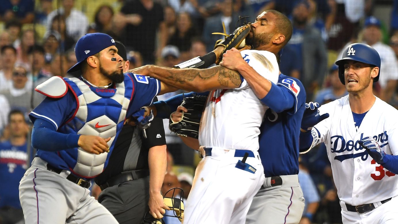 Los Angeles Dodgers outfielder Matt Kemp and Texas Rangers catcher Robinson Chirinos get in a scuffle after a collision at home plate on Wednesday, June 13 in Los Angeles. The benches cleared after Kemp ran Chirinos over in a play in the third inning. Both players will be suspended for one game over the dust-up.