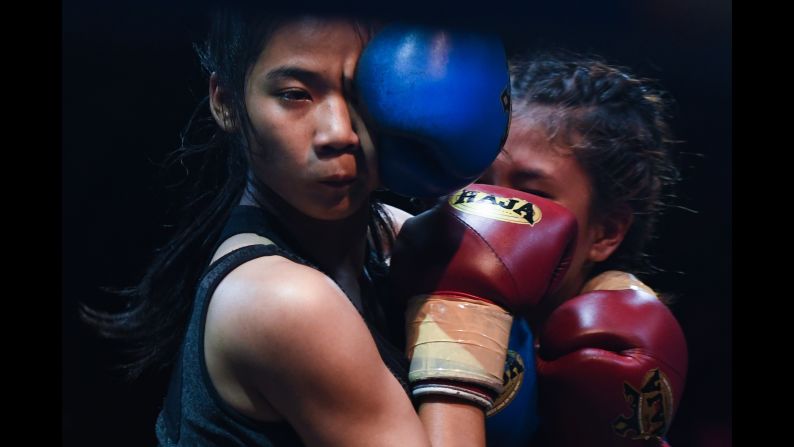 Plerngwaree, left, and Nonggift compete during the muay thai Monday Evening International Thai Boxing Gala in Chiang Mai on Monday, June 11.