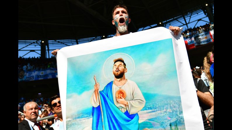 A fan from Argentina holds a drawing depicting Argentina's Lionel Messi as Jesus before the World Cup match between Argentina and Iceland on Saturday, June 16.