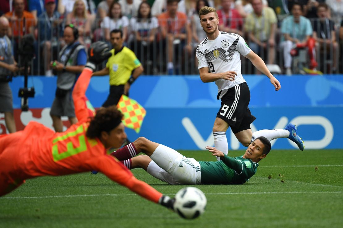 Mexico's goalkeeper Guillermo Ochoa (front) saves a shot from Germany's forward Timo Werner (top).