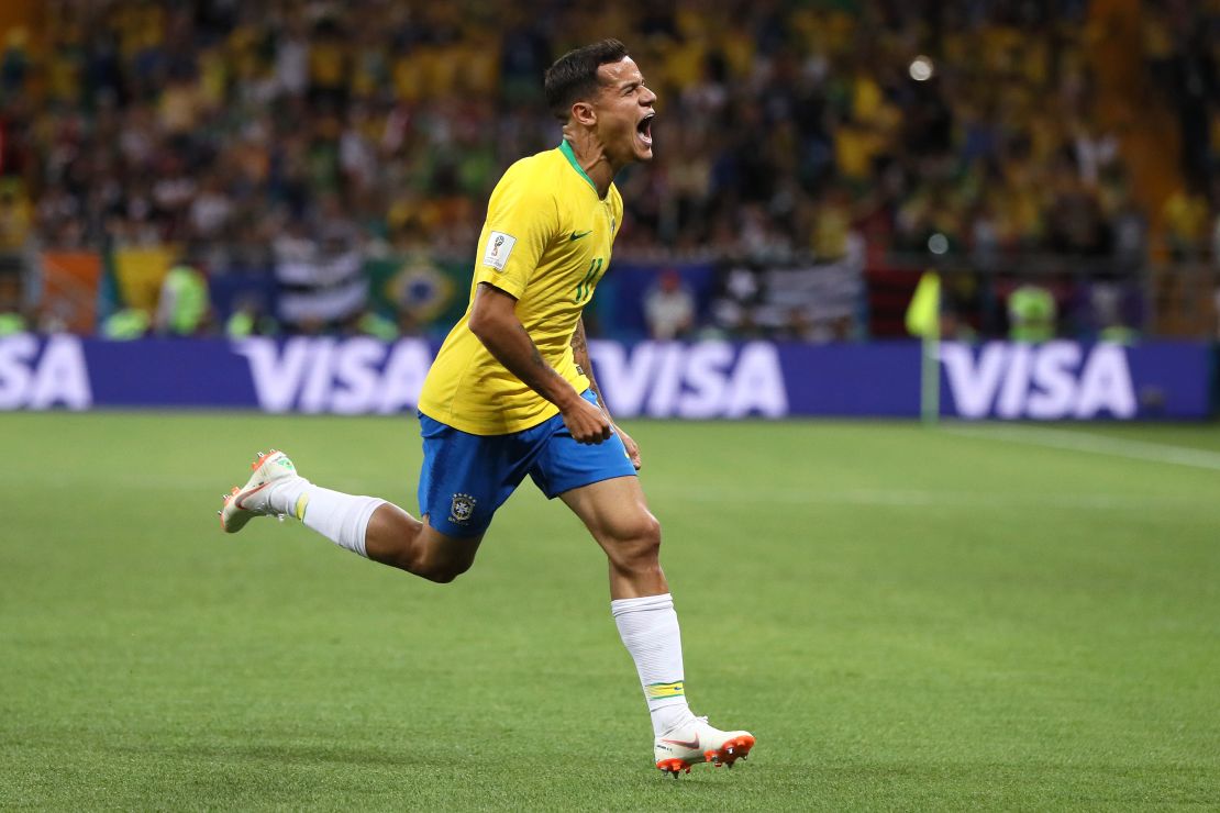 Philippe Coutinho wheels away after curling home Brazil's opener.