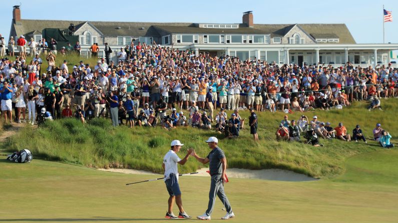 Brooks Koepka of the United States celebrates with caddie Richard Elliott during the final round of the US Open in Southampton, New York on Sunday, June 17. Koepka defended his crown at the year's second major, becoming the first golfer to repeat as champion since Curtis Strange in 1989.