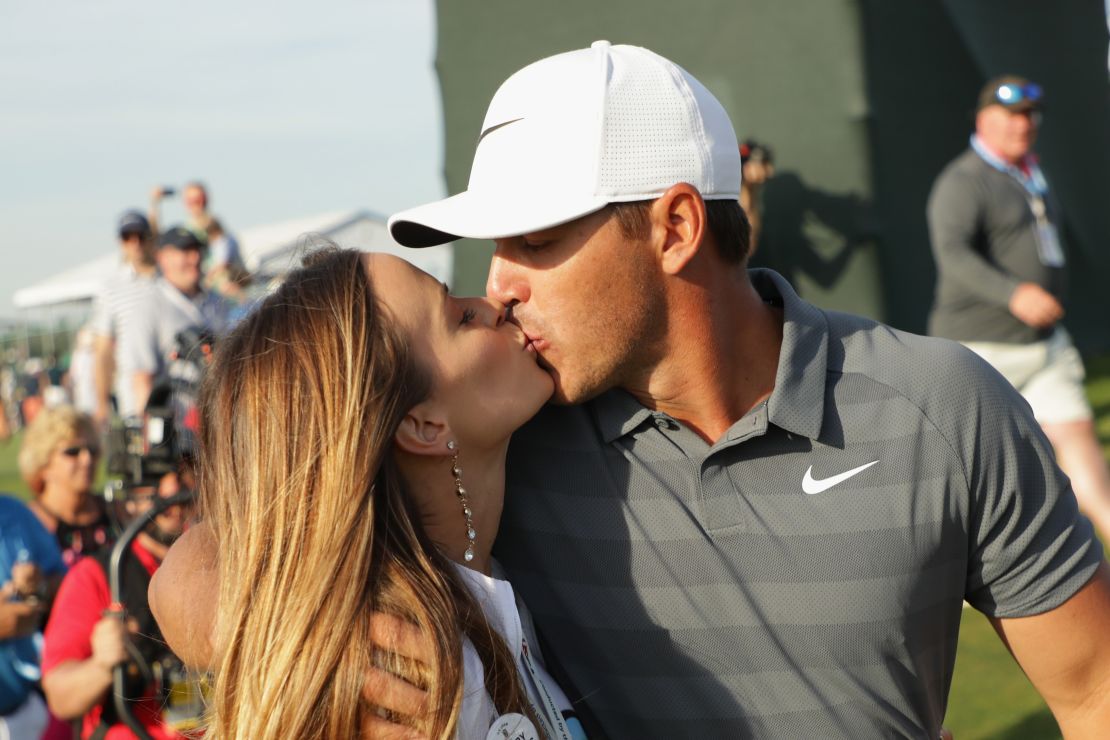 Brooks Koepka kisses girlfriend Jena Sims as he walks off the 18th at Shinneock Hills.