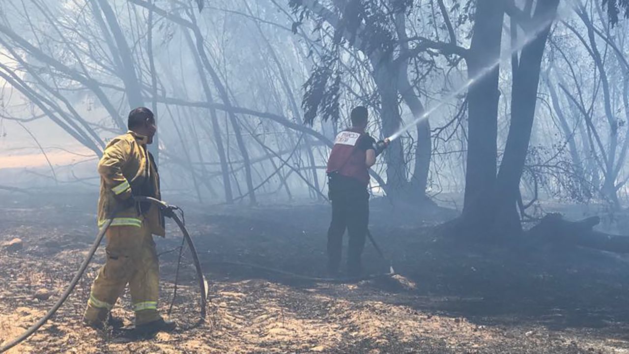 Firefighters tackle a blaze in Kissufim, close to the Israel border with Gaza.