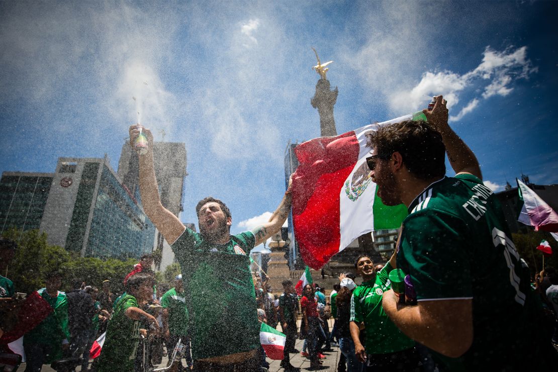 Mexicans celebrate at the Angel of Independence in the country's capital, following the national team's historic victory over Germany in the 2018 FIFA World Cup.